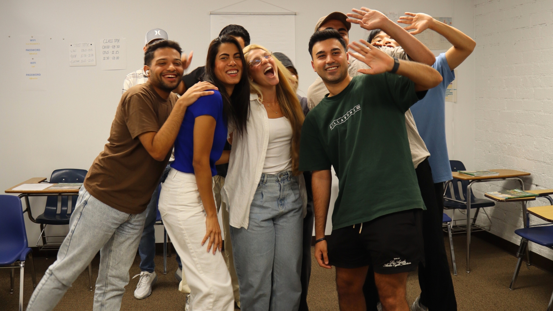 A group of California Language Academy students smiling together in a classroom
